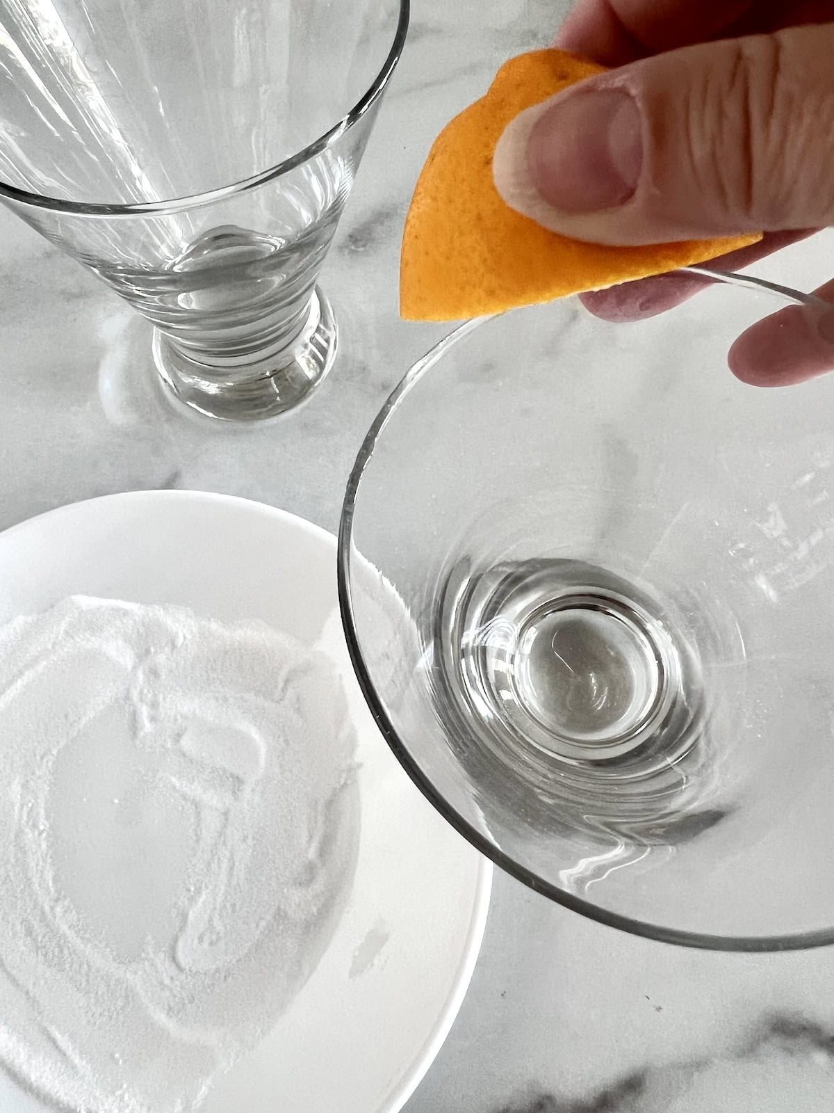 Rubbing glass rim with lemon wedge.