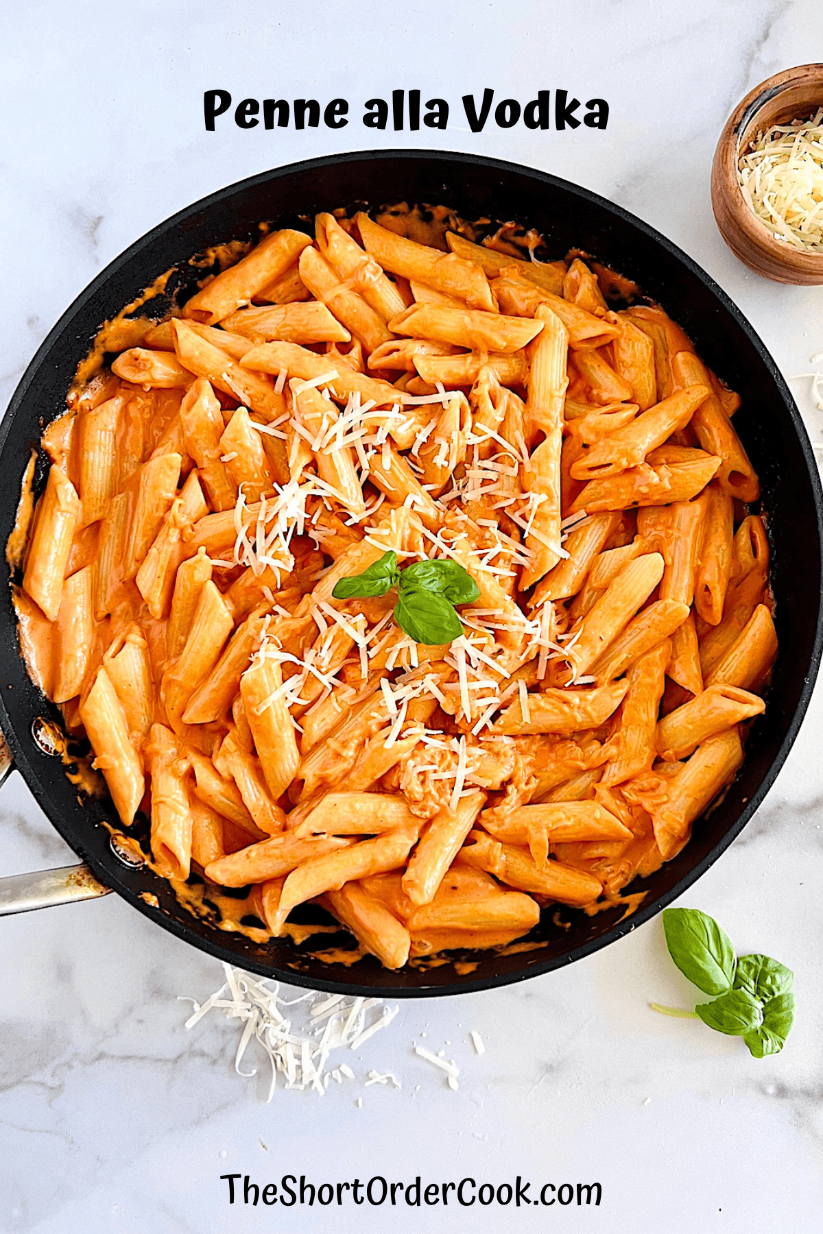 Large skillet with penne pasta served with a homemade creamy tomato vodka sauce.