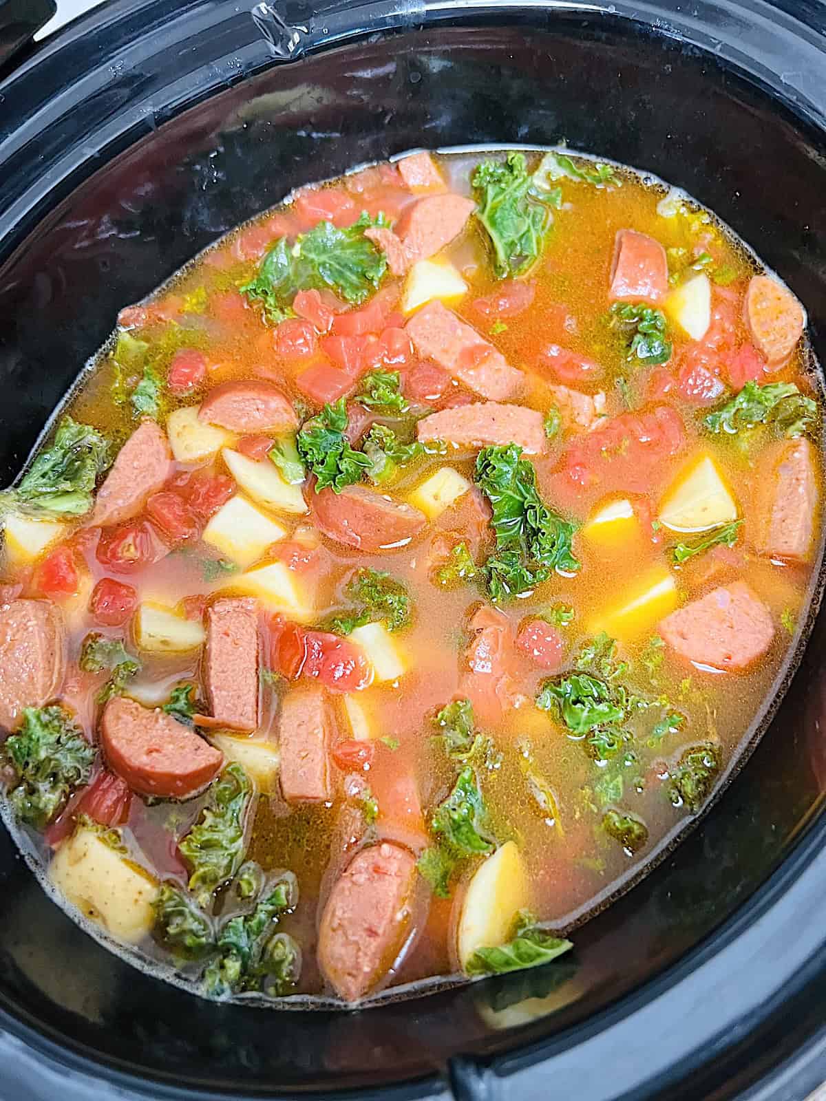 Slow Cooker Sausage Kale Soup Water added to make broth in Crockpot.
