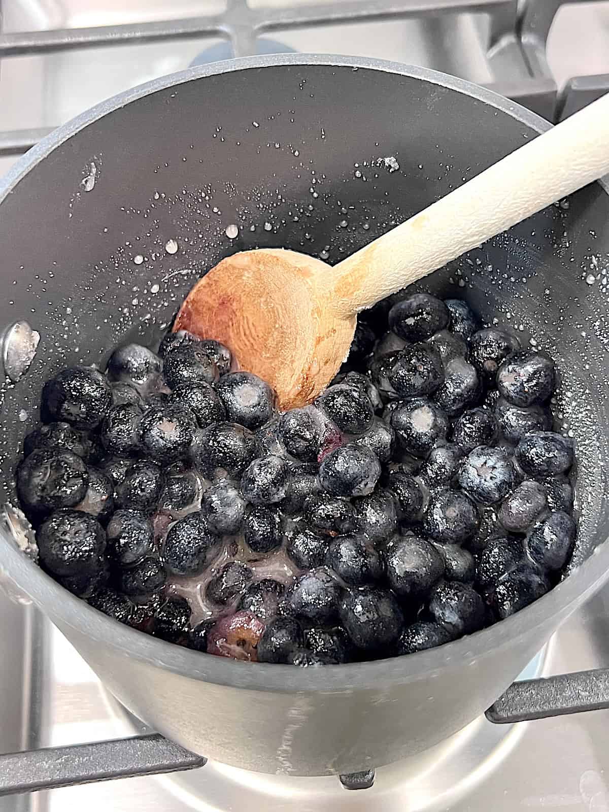 Blueberry Ice Cream Cooking berries on the stovetop.