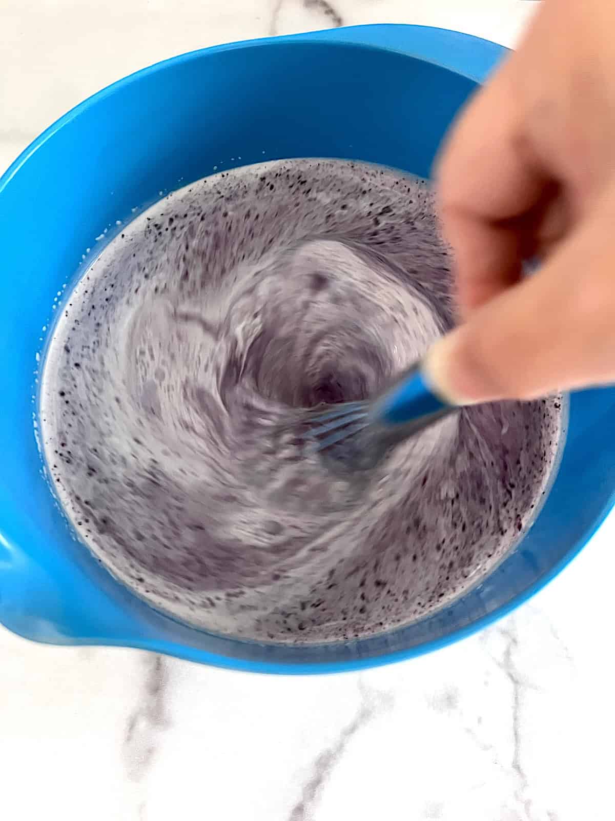Blueberry Ice Cream Whisking pureed berries into ice cream base.