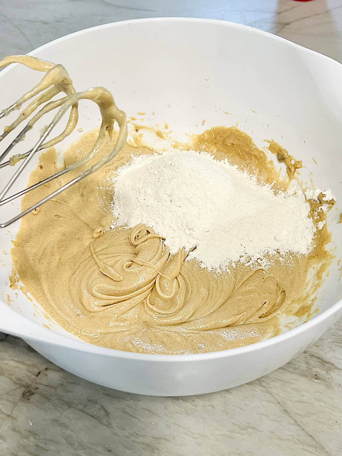 Adding dry ingredients to wet.