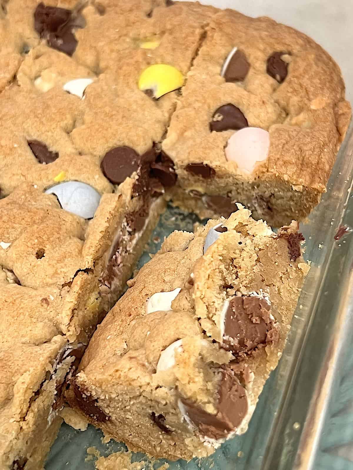 Cadbury Mini Egg Cookie Bars One Cut in the pan.