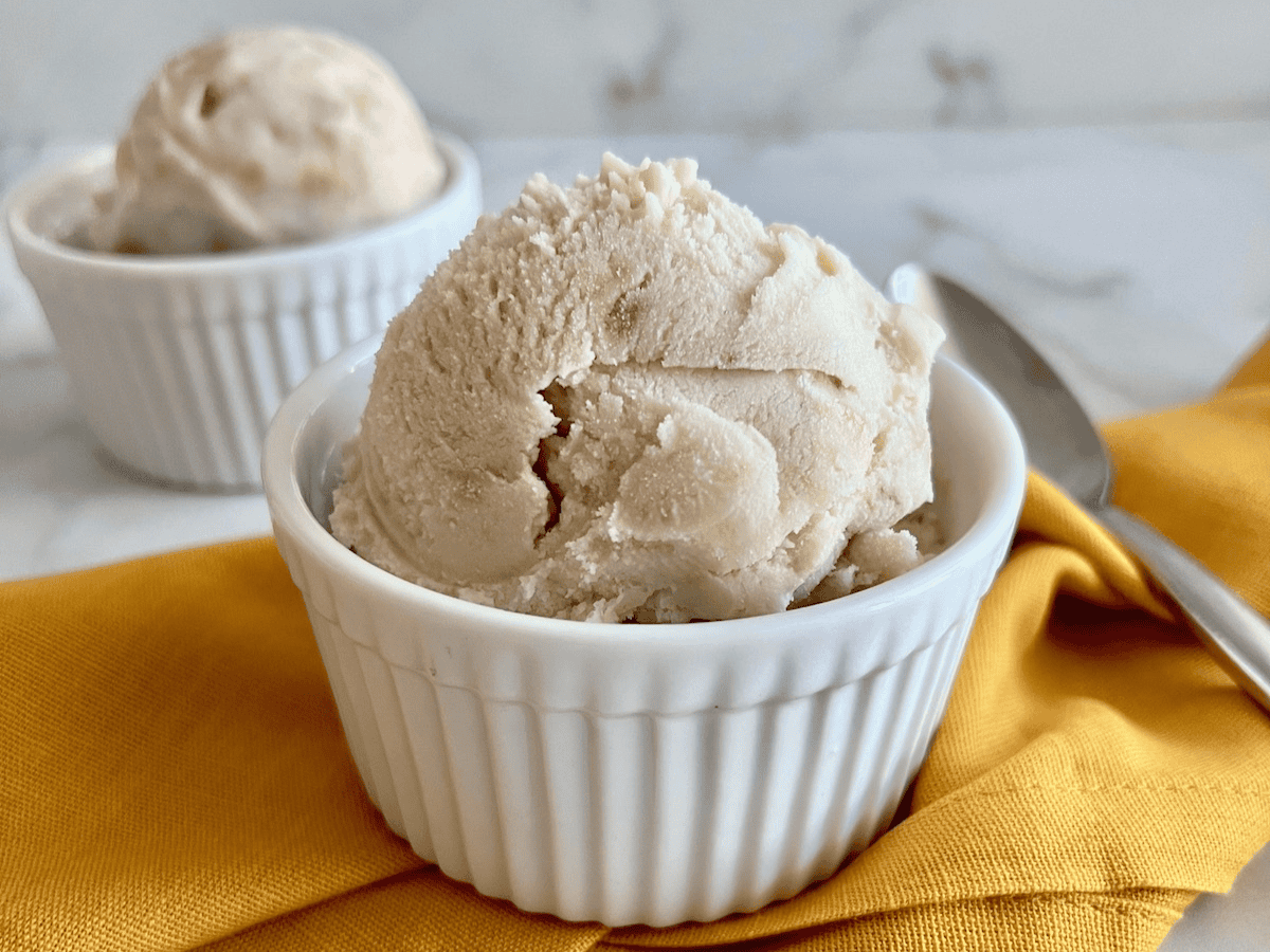 Two bowls with scoops of homemade banana ice cream made with real fruit.