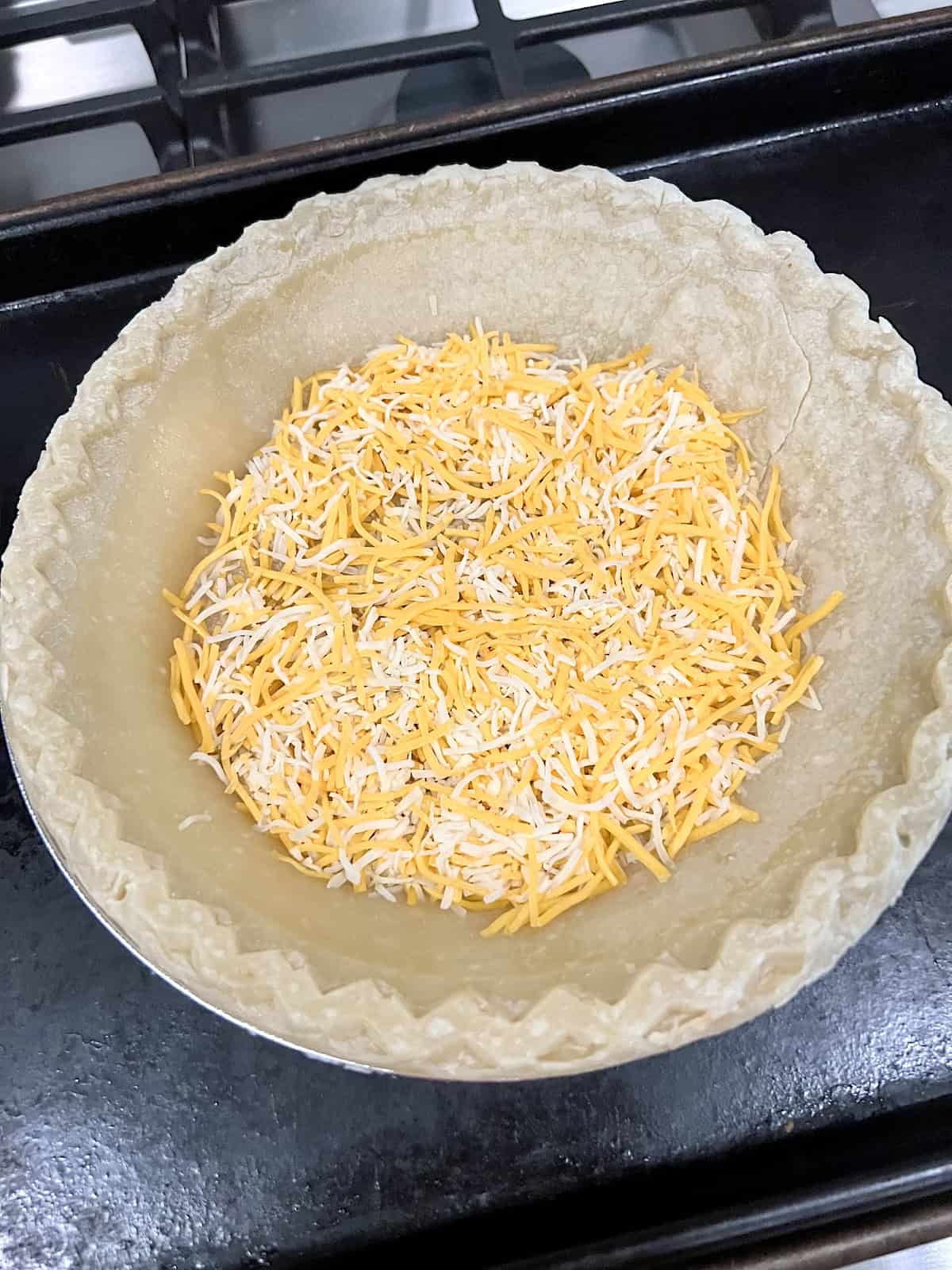 Crust topped with shredded cheese in the bottom.