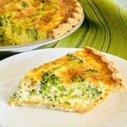 Broccoli Cheese Quiche Recipe made with frozen pie crust, slice on a plate ready to eat.