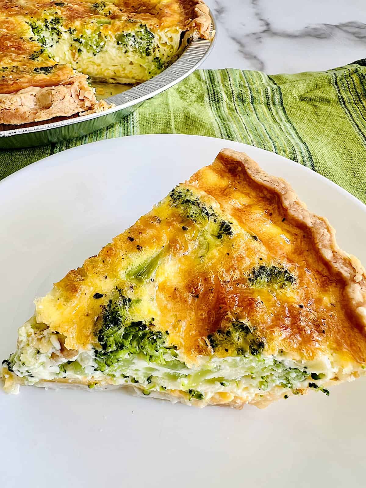 Broccoli Cheese Quiche Slice served on a plate ready to eat.