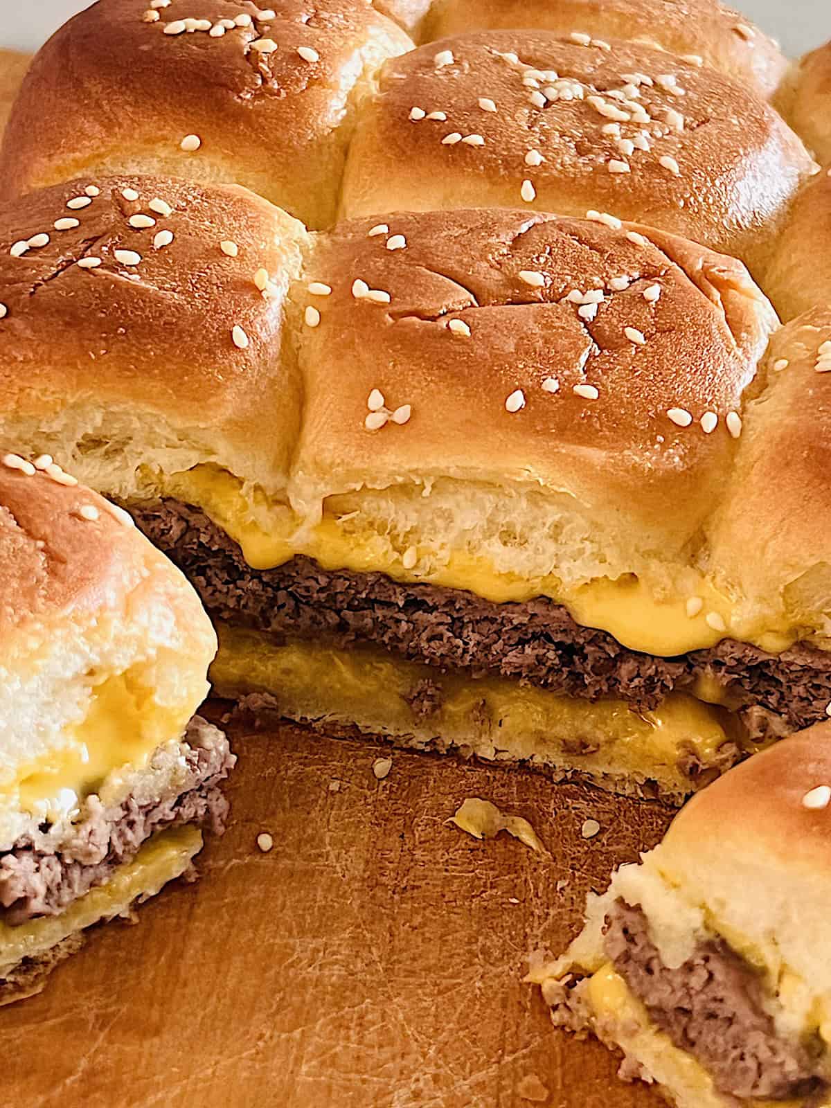 Cheeseburger Sliders Cut into two individual burgers showing layers.