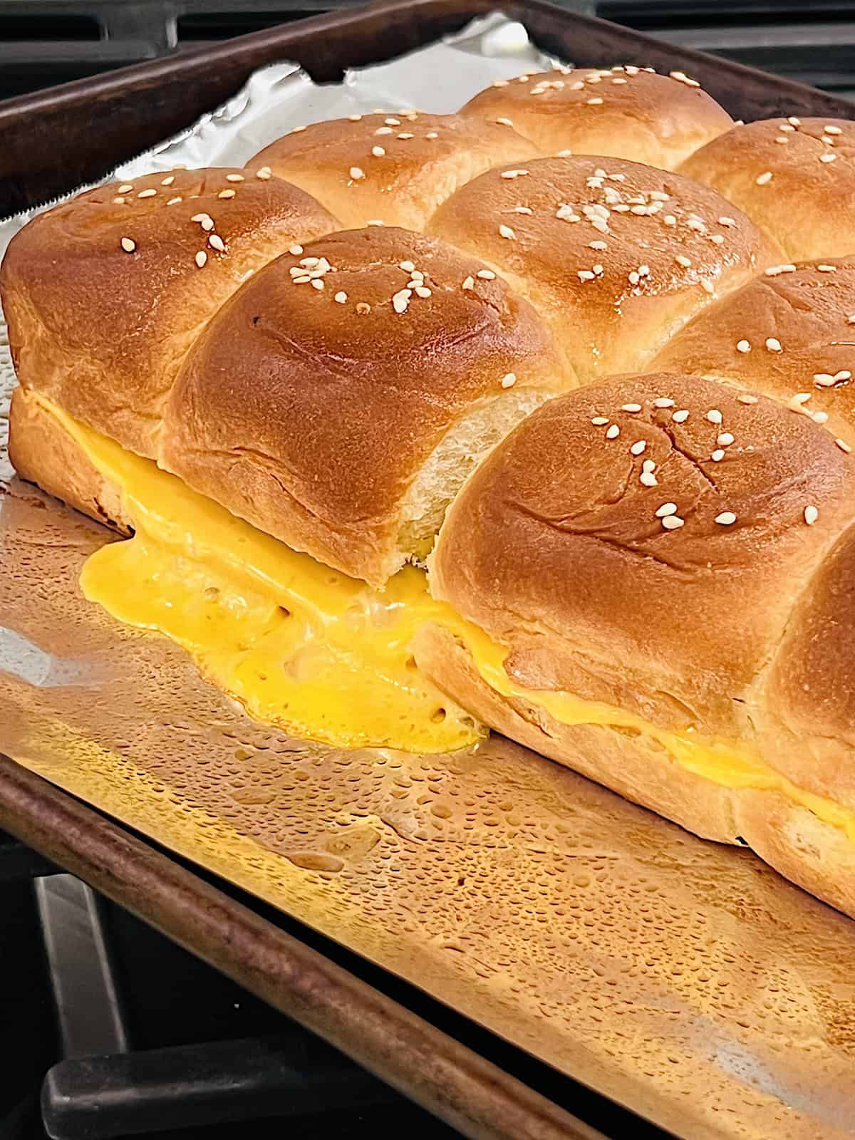 Cheeseburger Sliders Hot out of the oven with melting cheese oozing out.