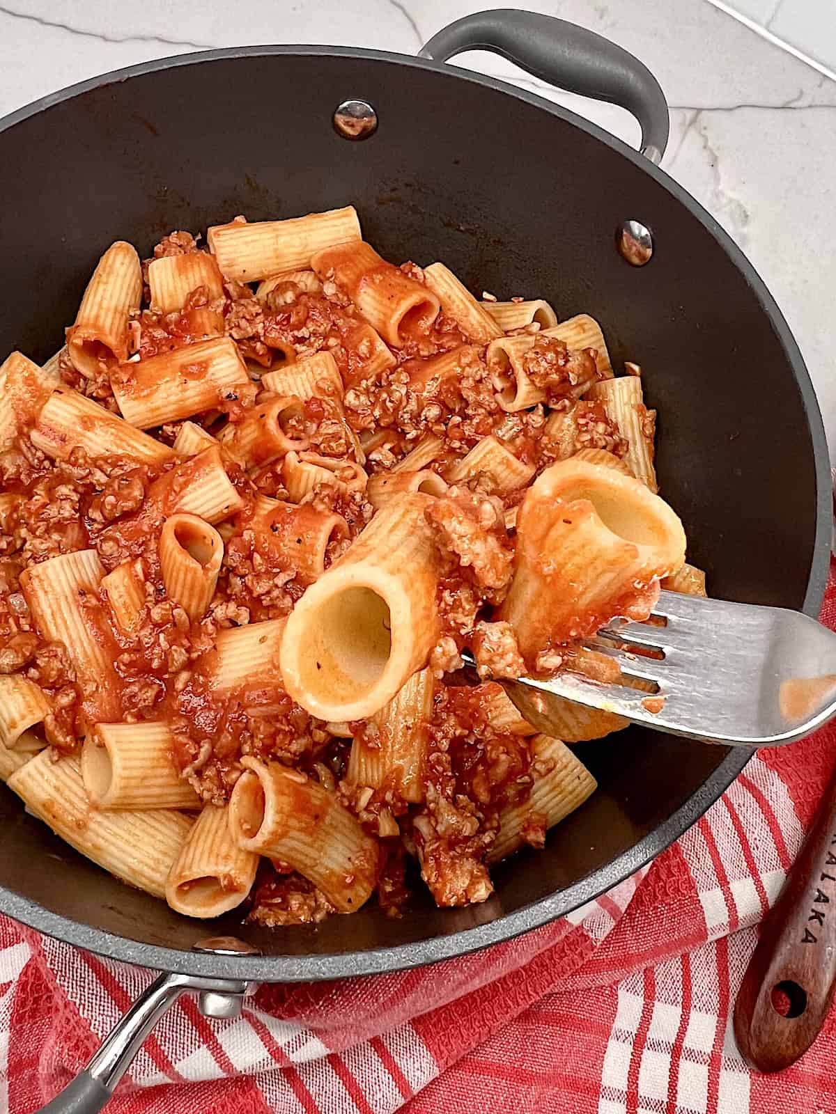 Rigatoni and Meat Sauce Fork with a bite ready to eat.