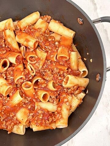 Rigatoni and Meat Sauce in a pot with garlic tomato sauce and Italian spices
