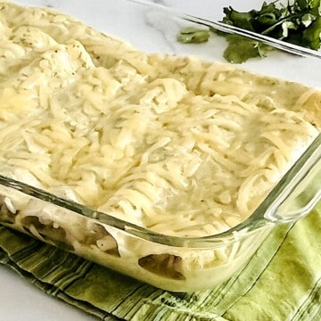 Enchiladas Suizas with shredded chicken & cheese baked in green chile cilantro cream sauce.