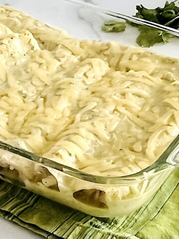 Enchiladas Suizas with shredded chicken & cheese baked in green chile cilantro cream sauce.