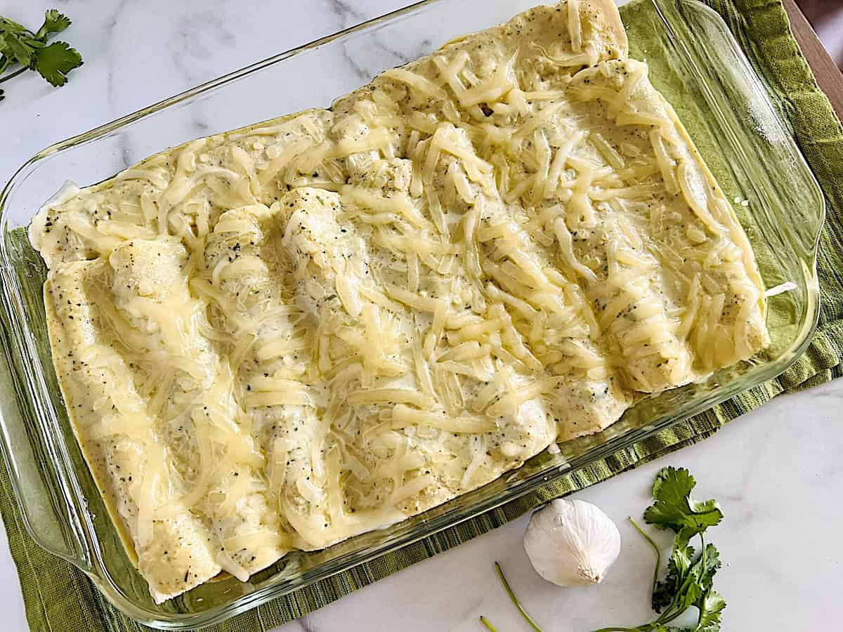 Enchiladas Suizas stuffed with chicken and cheese oven baked and ready to serve.