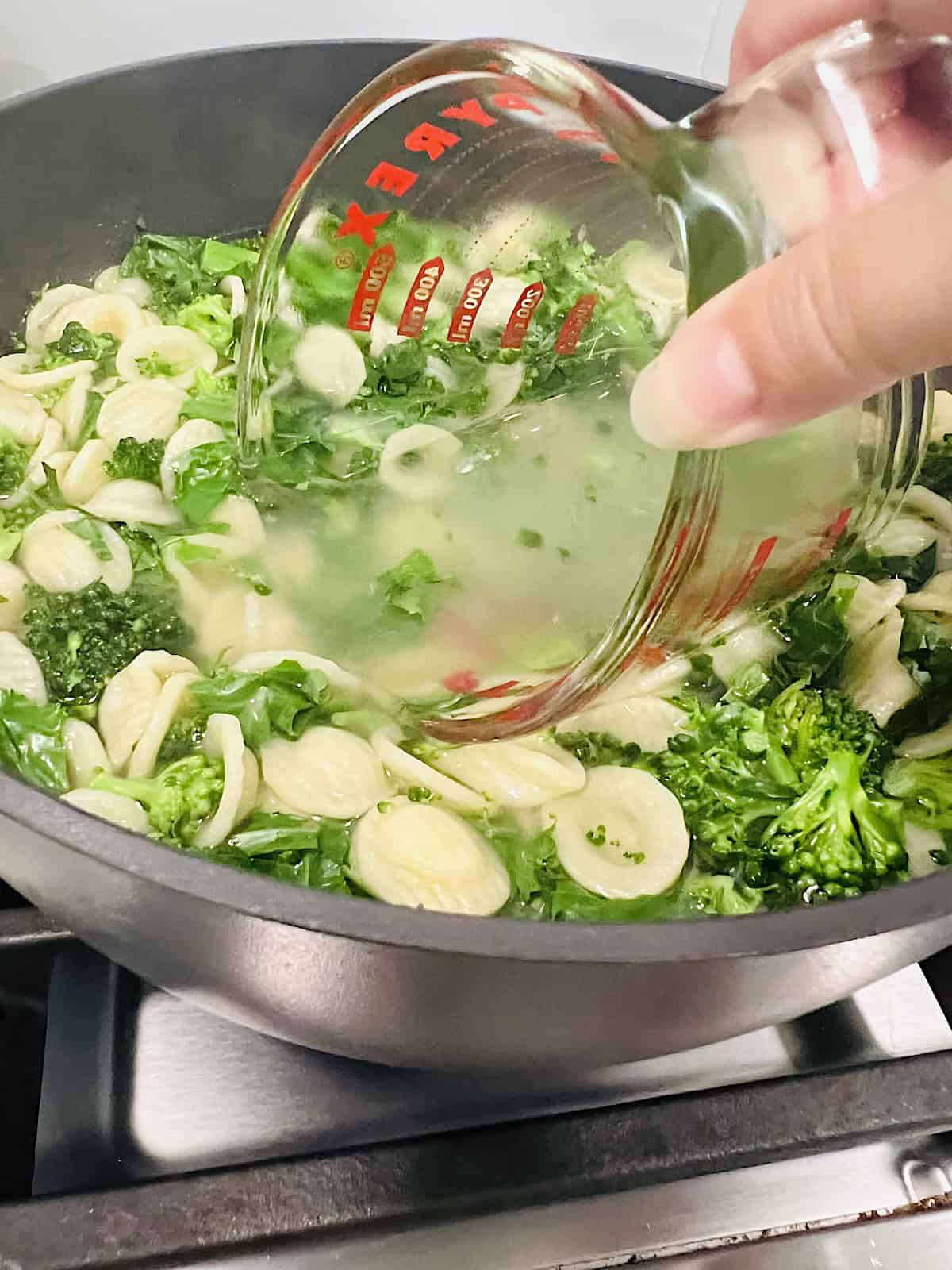 Orecchiette with Sausage and Broccoli Rabe Scooping pasta water to reserve.