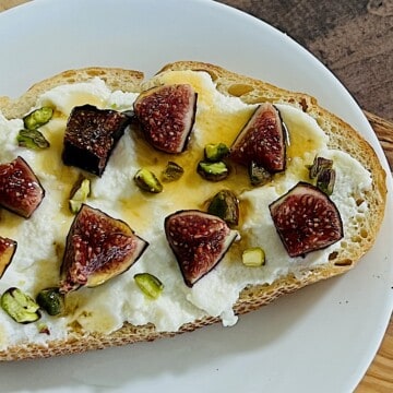 Ricotta Fig Toast topped with chopped pistachios and hot honey.