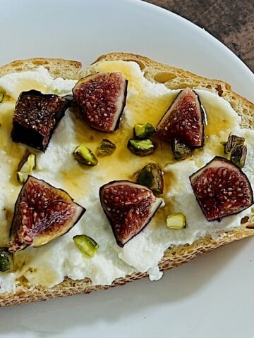 Ricotta Fig Toast topped with chopped pistachios and hot honey.