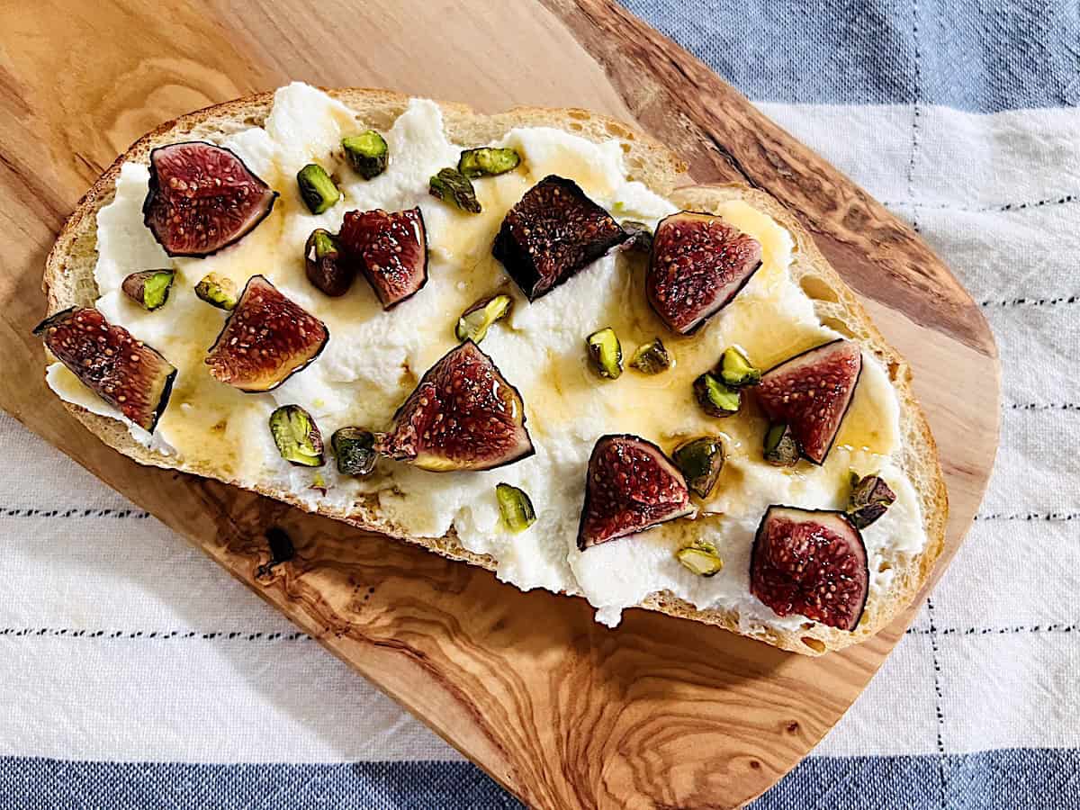 Italian Ricotta Fig Toast made with pistachios and hot honey drizzle on top of artisan crusty bread.