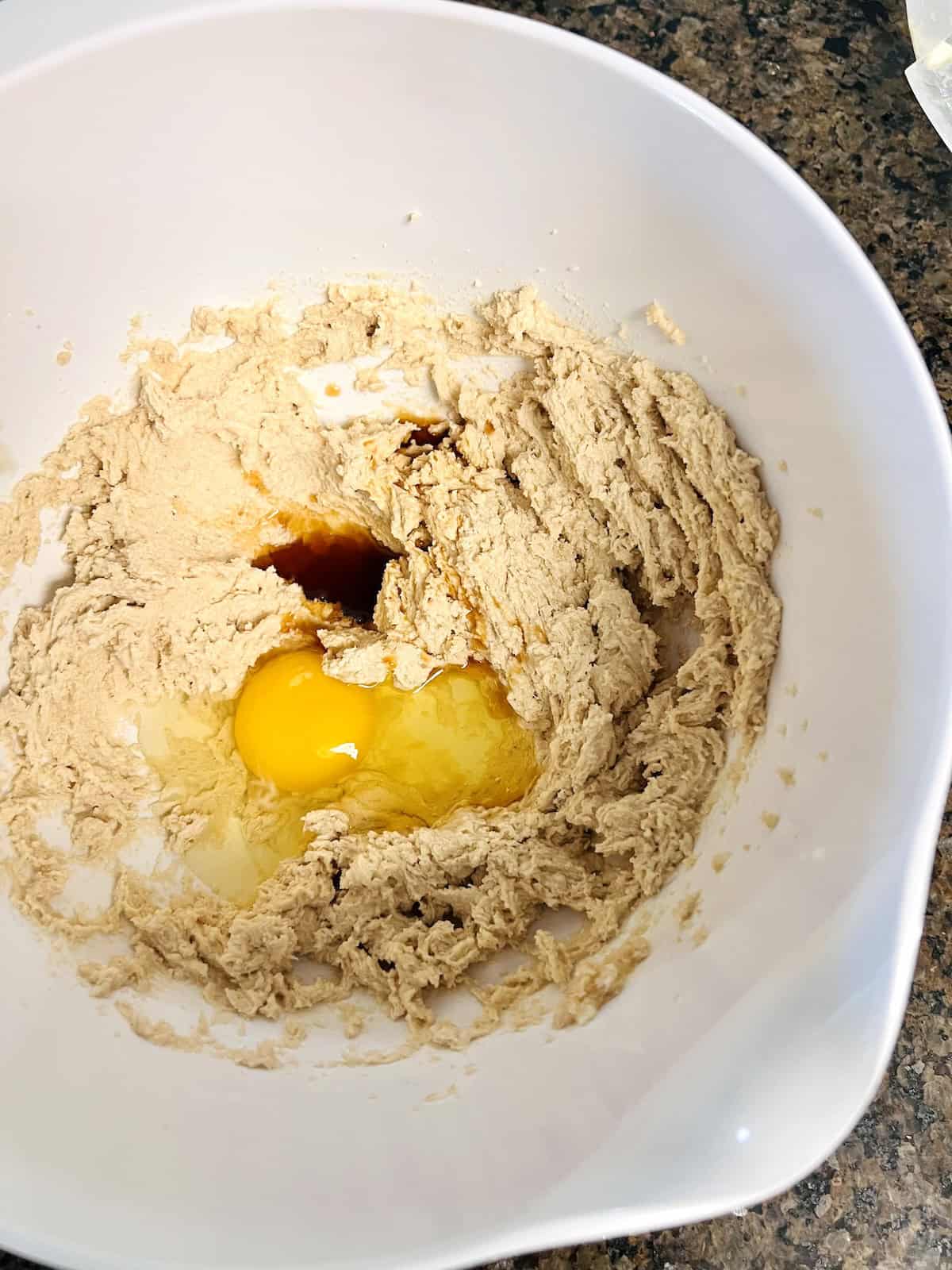 Adding eggs vanilla to creamed ingredients.