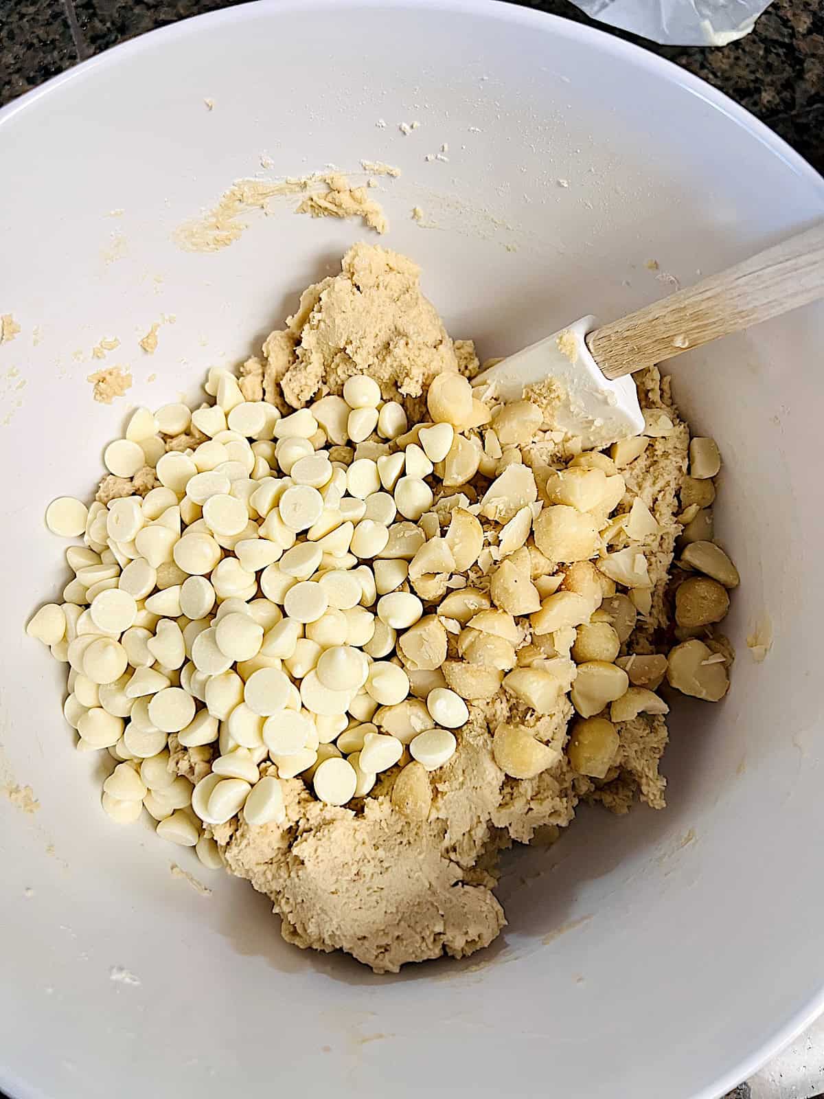 White Chocolate Macadamia Cookies Mixing in nuts and chips into dough.