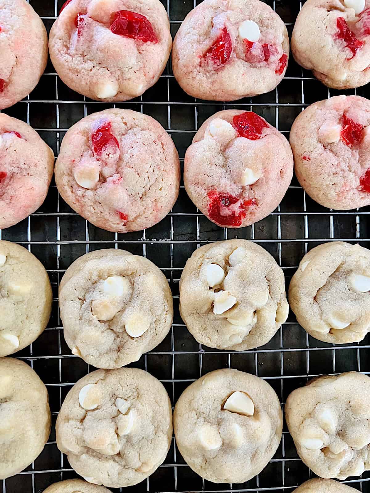White Chocolate Macadamia Cookies and Cherry White Chocolate Chip cookies on a wire rack.
