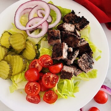 Healthy Burger Bowl with diced beef patty, lettuce, pickles, onion, & tomatoes.