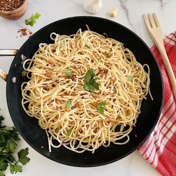 Spaghetti Aglio Olio e Peperoncino pasta with olive oil garlic and chili in a pan ready to eat.
