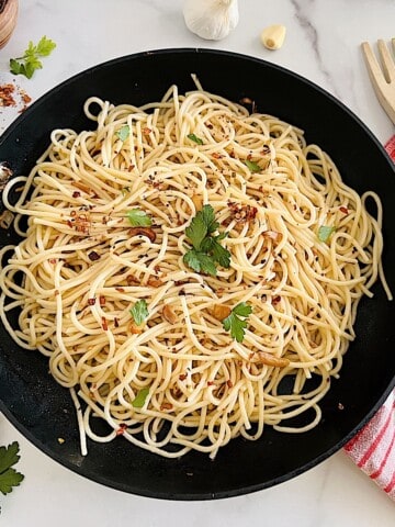 Spaghetti Aglio Olio e Peperoncino pasta with olive oil garlic and chili in a pan ready to eat.