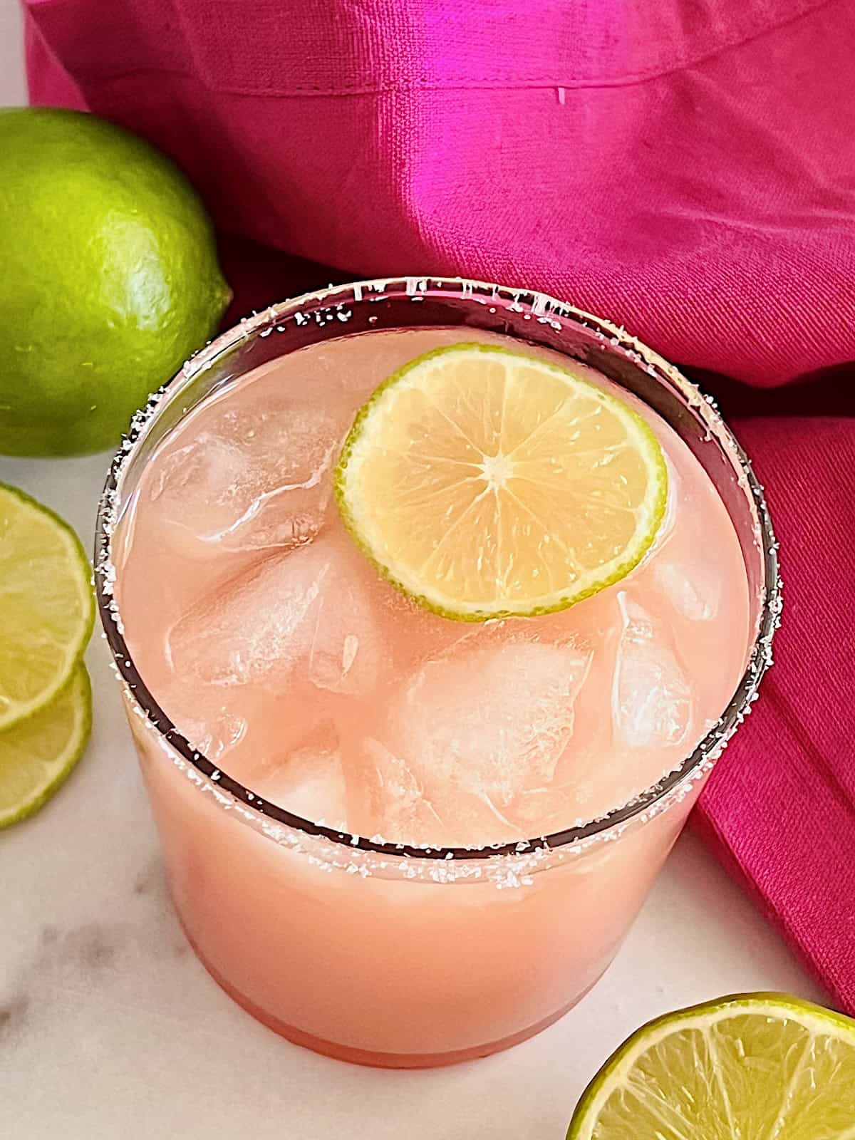 Guava Margarita Best guavarita recipe with tequila fruit juice and lime in a salted glass on the rocks