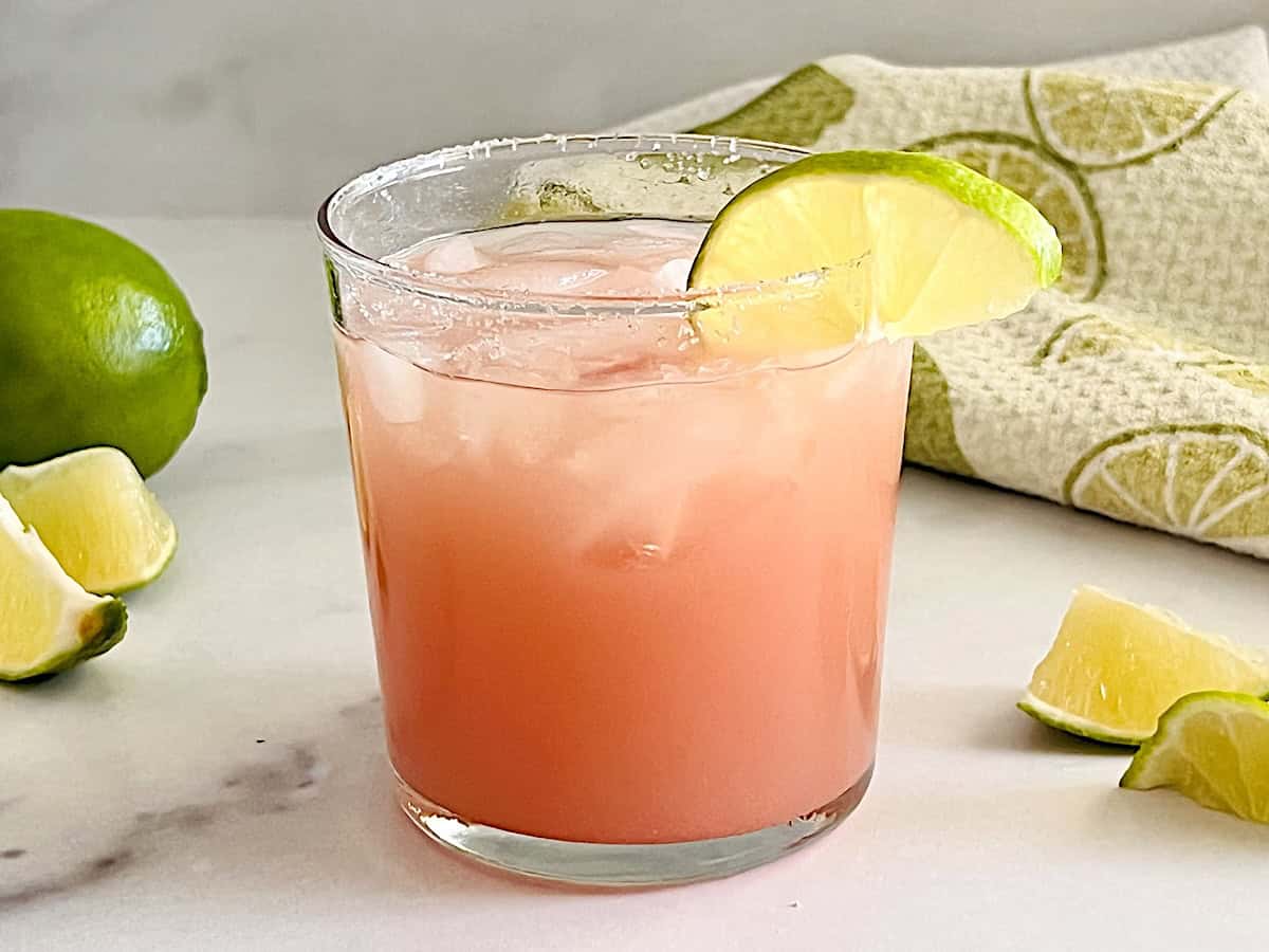 Guava Margarita tequila cocktail recipe with tropical fruit, lime juice, & served on the rocks.