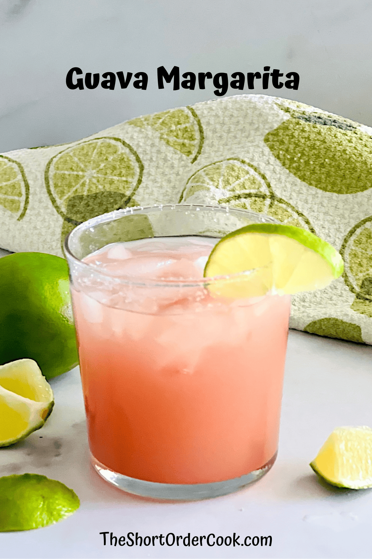 Glass of guavarita cocktail made with guava nectar, tequila blanco, fresh limes, & served over ice.