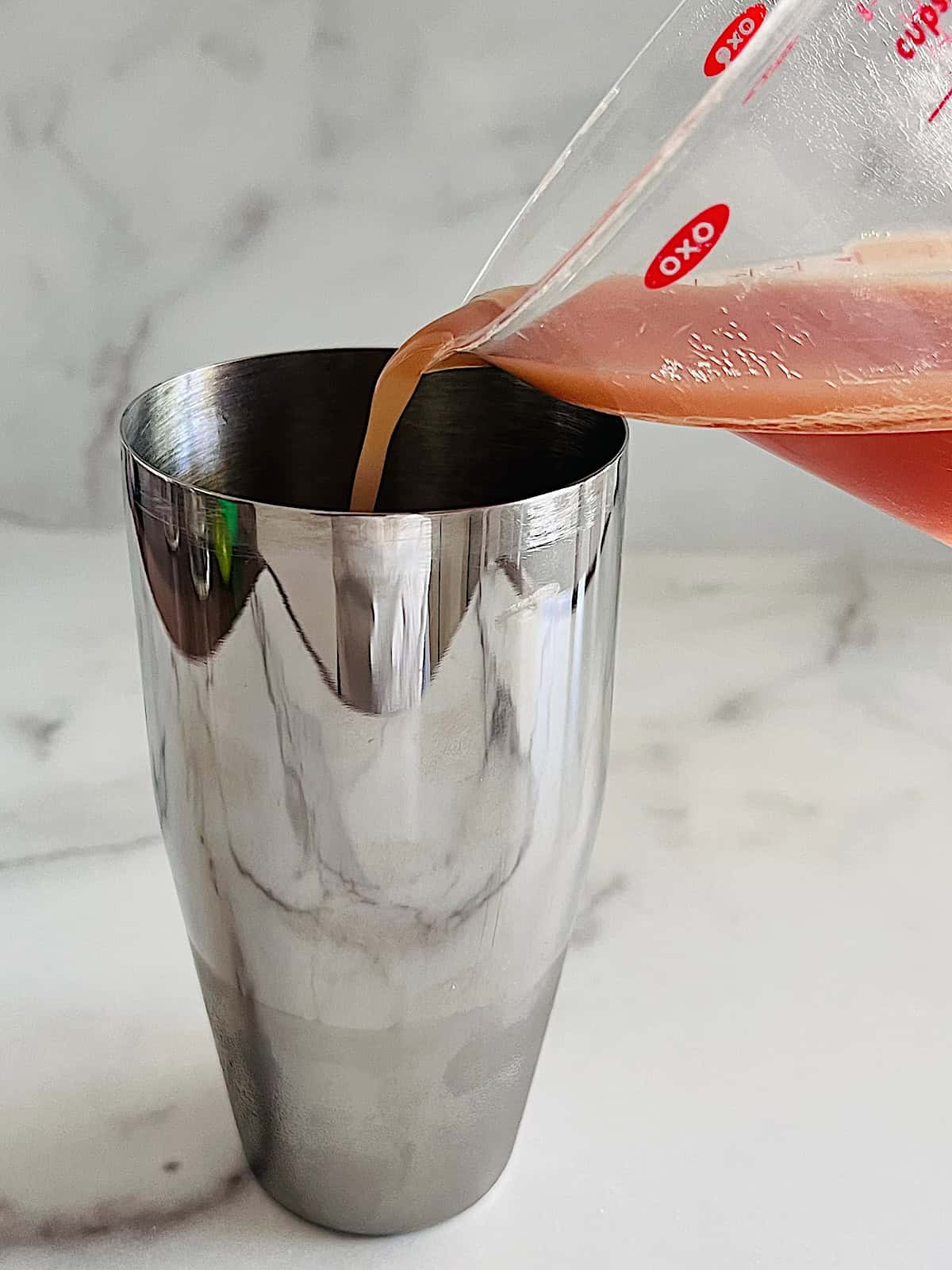 Pouring juice in shaker.