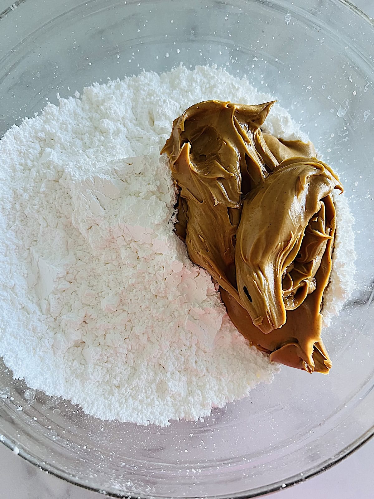 Adding pb and powdered sugar to bowl.
