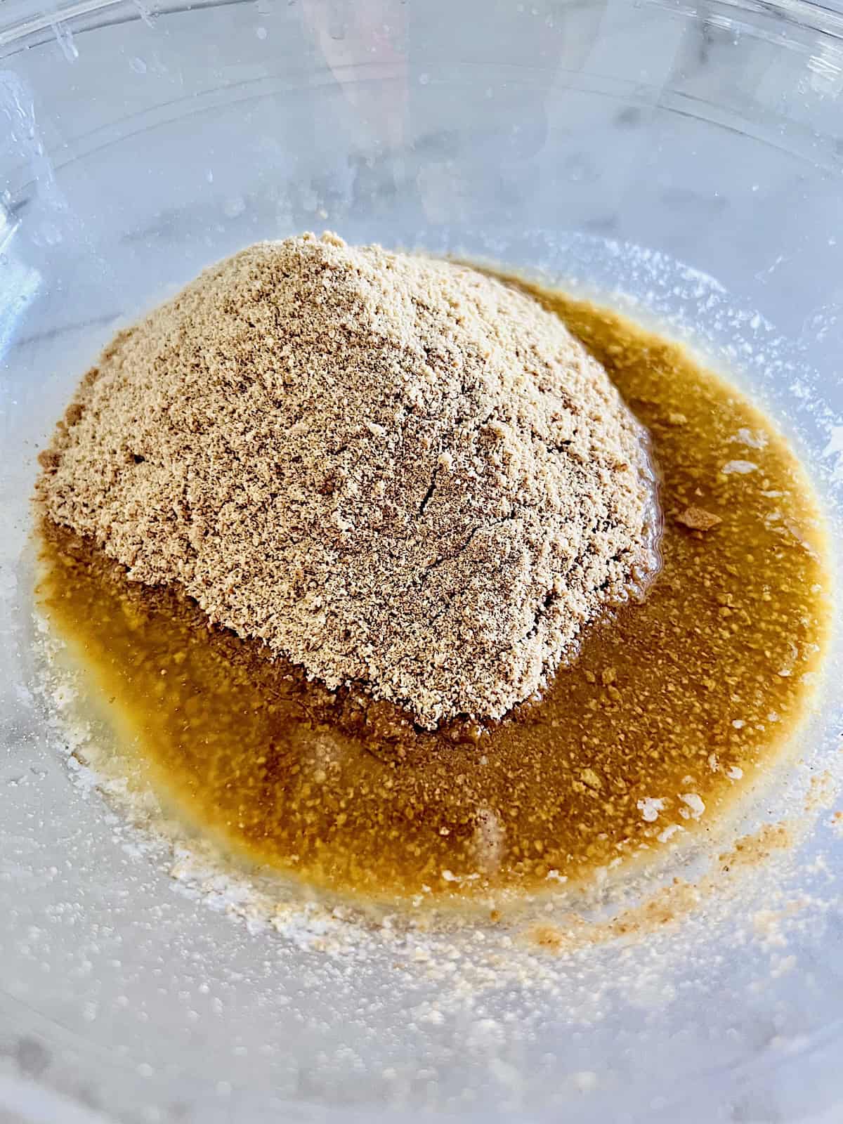 Bowl with crushed graham crackers and melted butter.