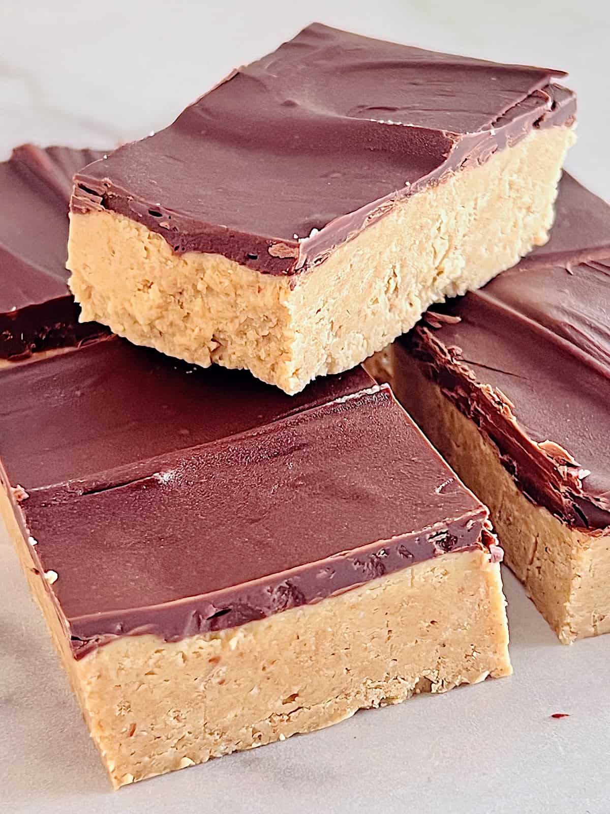 No Bake Chocolate Peanut Butter Bars Cut into squares stacked ready to eat.