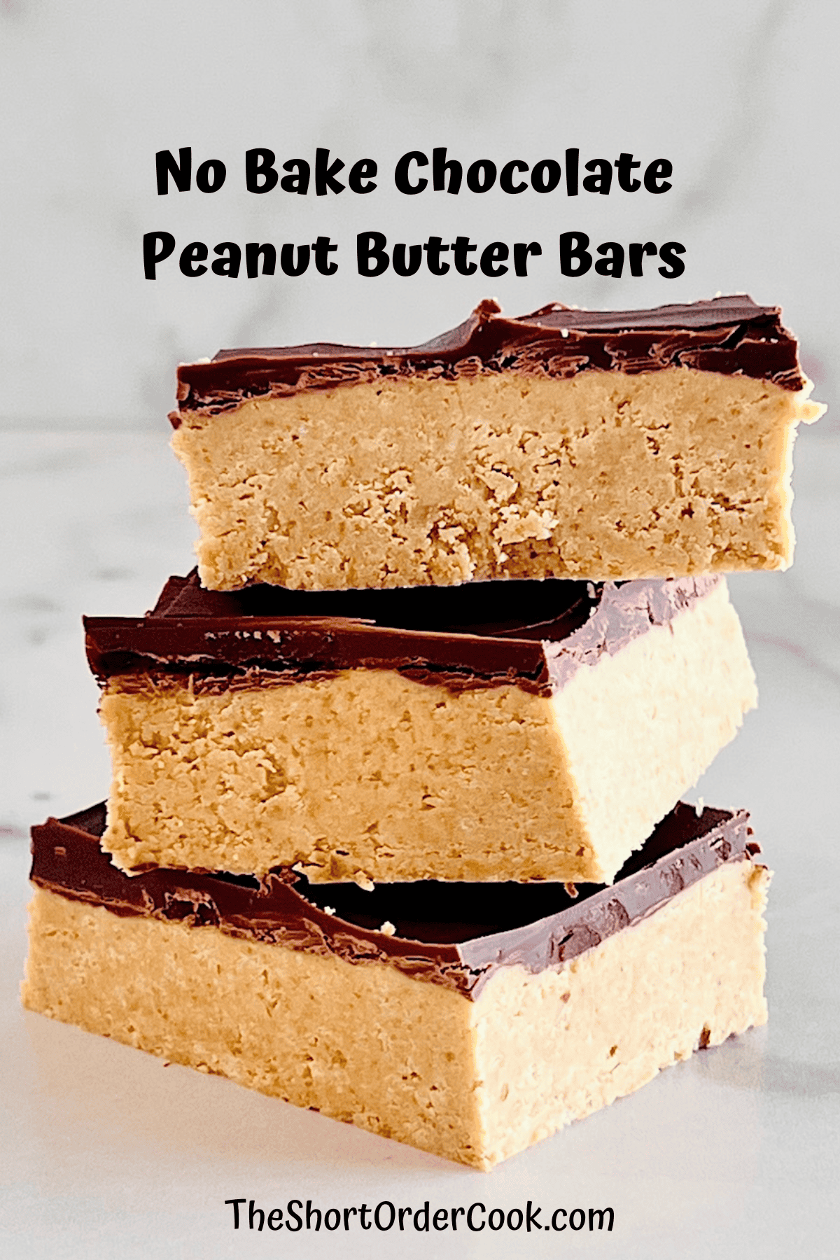 No Bake Chocolate Topped Creamy Peanut Butter Bars stacked up.