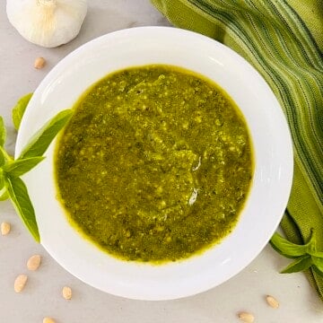 Bowl of Basil Pesto Sauce (Pesto alla Genovese) made with fresh basil, garlic, pine nuts, olive oil and Parmesan.