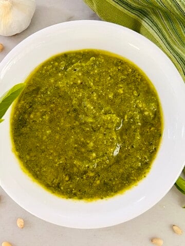 Bowl of Basil Pesto Sauce (Pesto alla Genovese) made with fresh basil, garlic, pine nuts, olive oil and Parmesan.