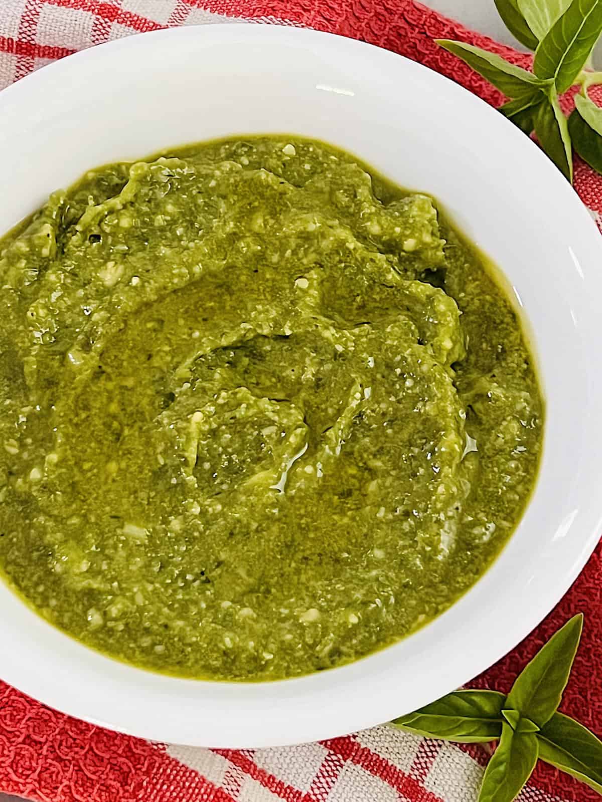 Basil Pesto Sauce (Pesto alla Genovese) Ready in bowl made with garlic pine nuts and parmesan cheese.