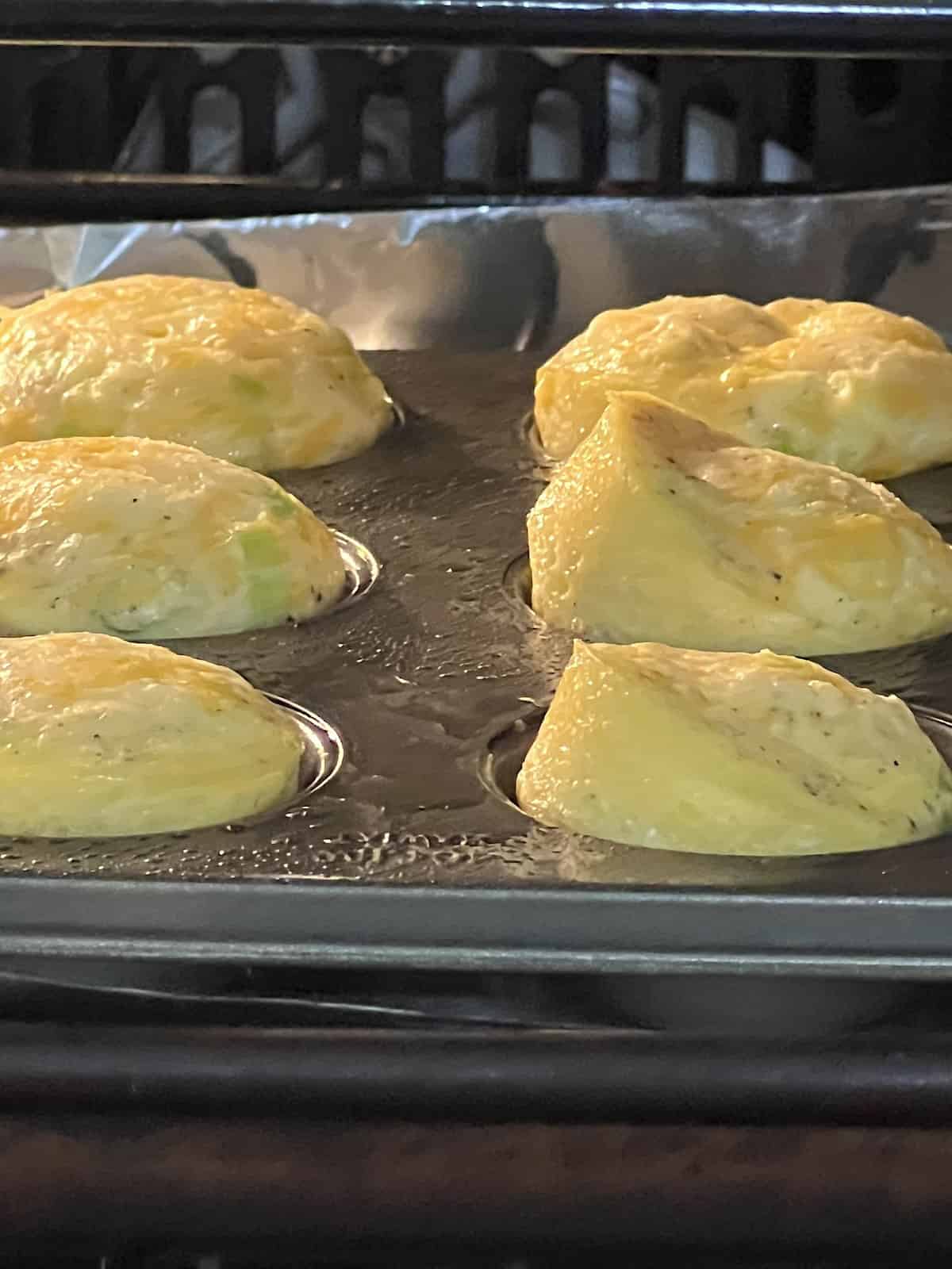 Mini Egg Bites Puffing up as baking in oven like souffles.
