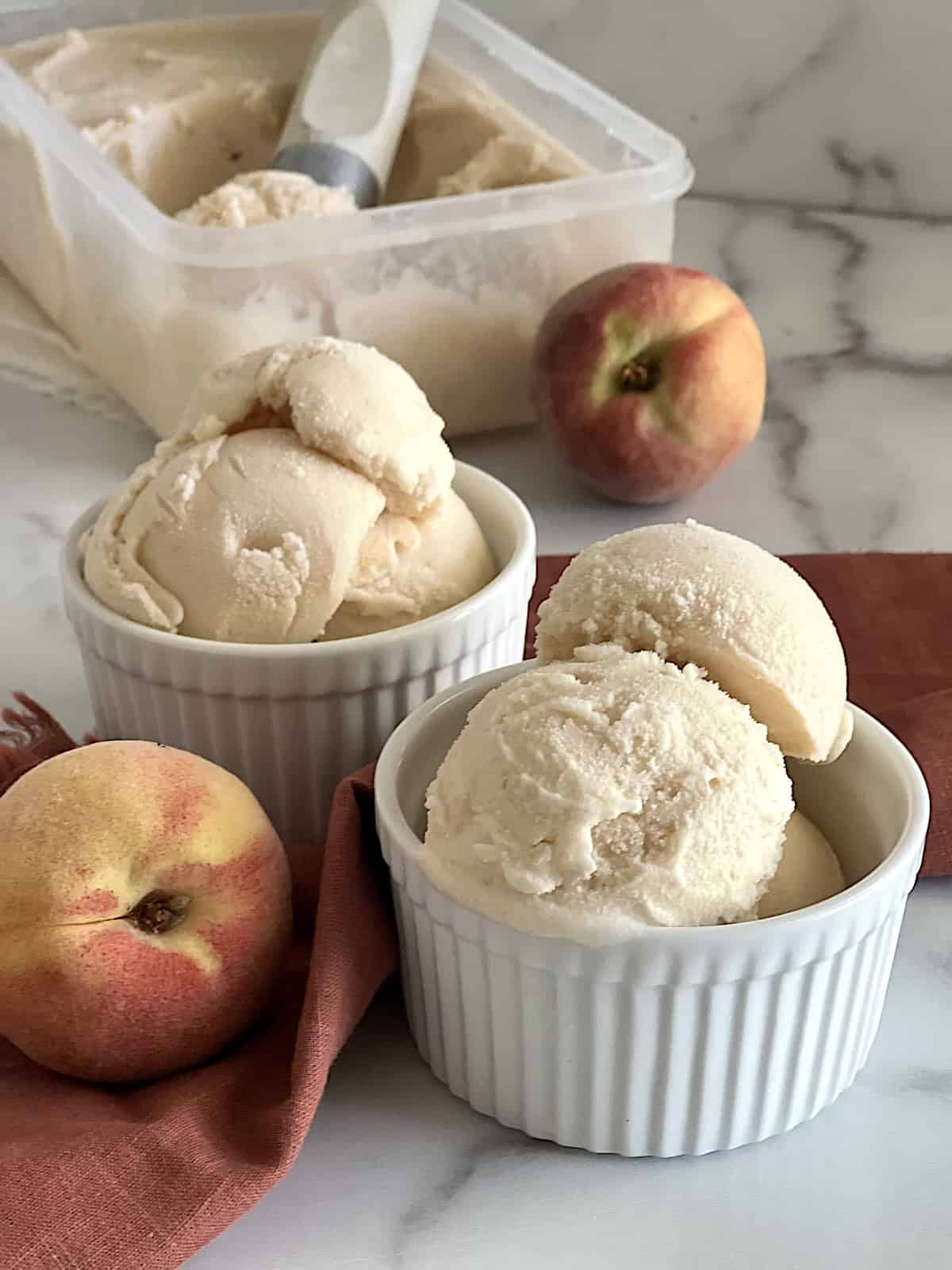 Peach Ice Cream Serving scoops into bowls.