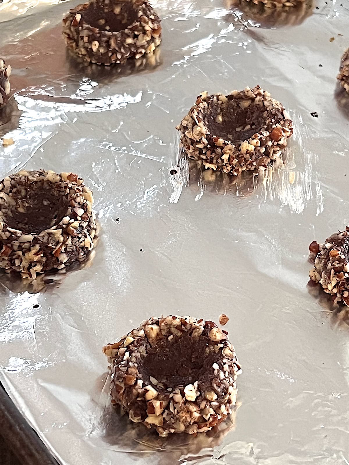 Turtle Thumbprint Cookies Dough pressed to indent cookies before baking.