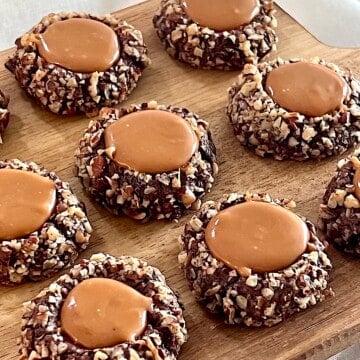 Turtle Thumbprint Cookies with chopped pecans and caramel centers.