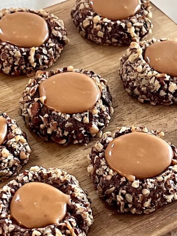 Turtle Thumbprint Cookies with chopped pecans and caramel centers.