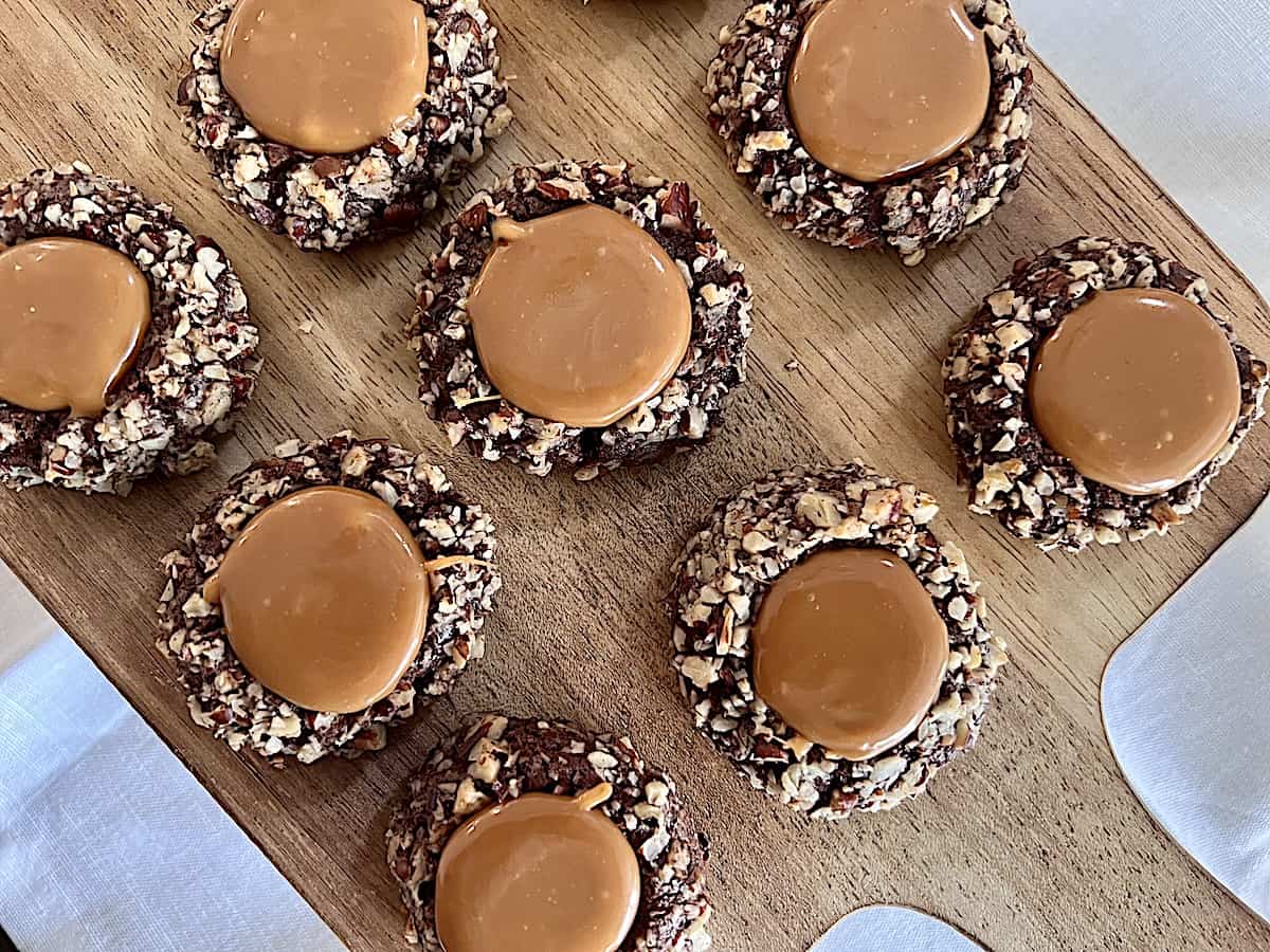 Cookie board with Chocolate Thumbprint Turte Cookies with crushed pecans and caramel centers.