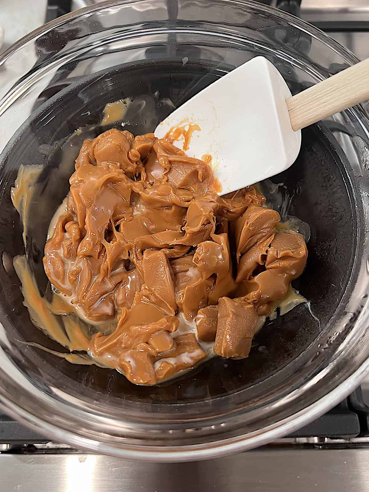 Melting caramel and cream in a double boiler on the stove