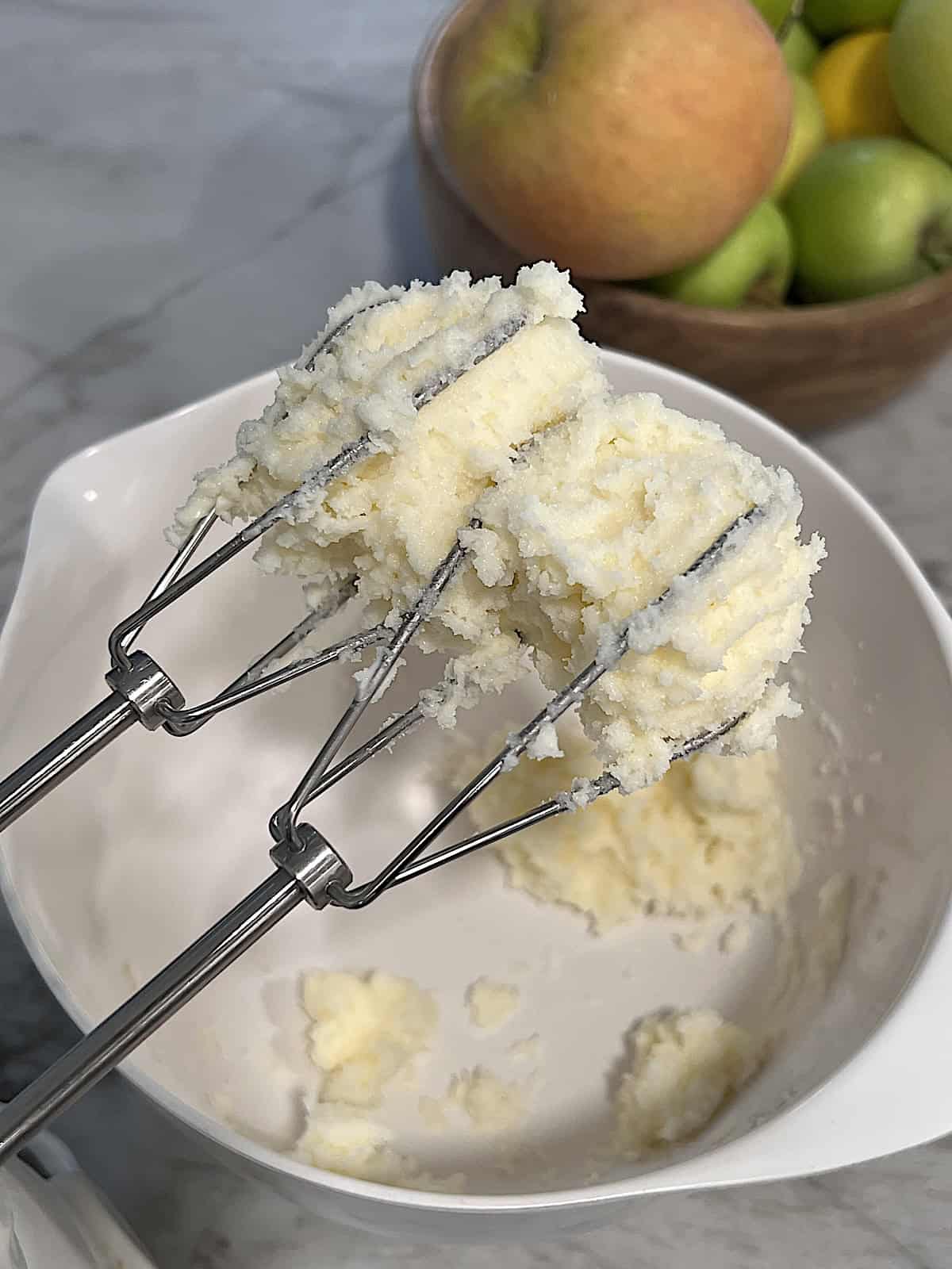 Creaming the butter and sugar in a bowl.