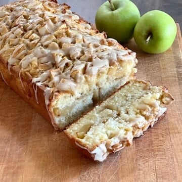 Apple Fritter Bread with Maple Glaze made with fresh apples cinnamon and spices in a loaf pan.