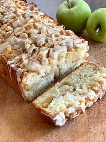 Apple Fritter Bread with Maple Glaze made with fresh apples cinnamon and spices in a loaf pan.