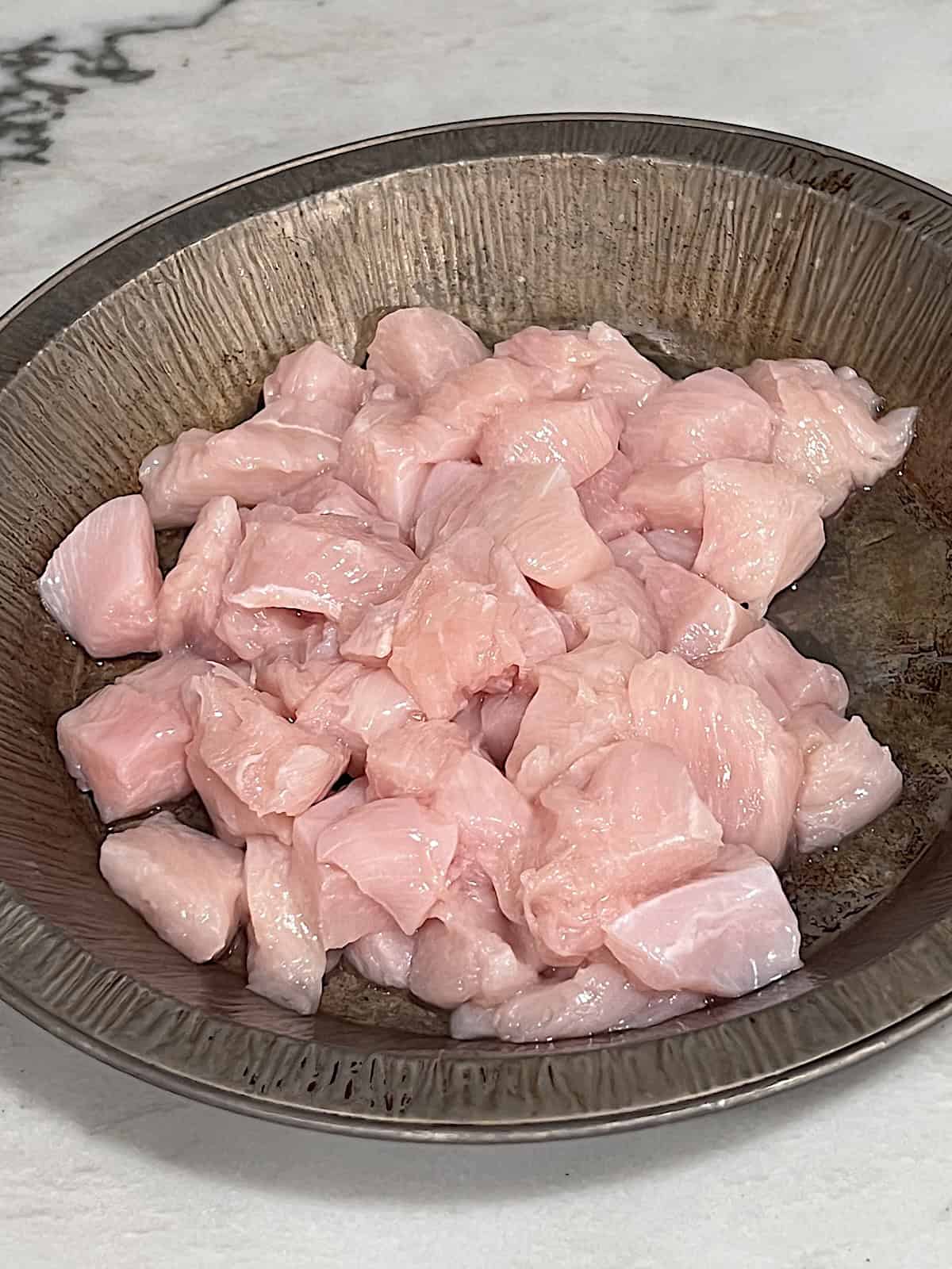 Diced raw chicken.
